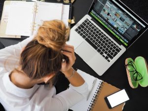 Stressed college student working at her laptop