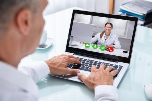 A patient has a video therapy session with his mental health practitioner.