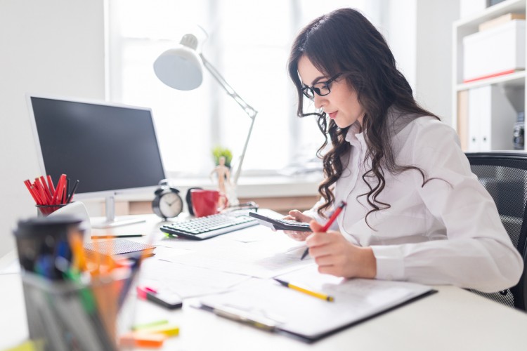 An accountant works at her desk.