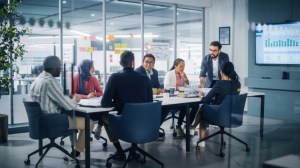 A marketing team meets around a conference table.