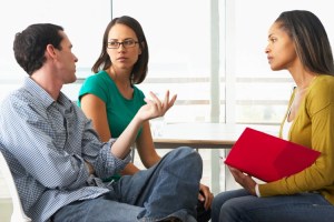 A counselor meets with a couple. 