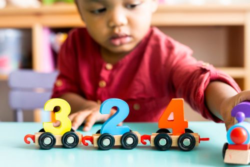 A child plays with number blocks