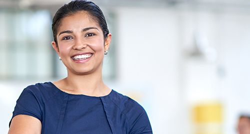 Undergraduate student wearing a blue dress, smiling