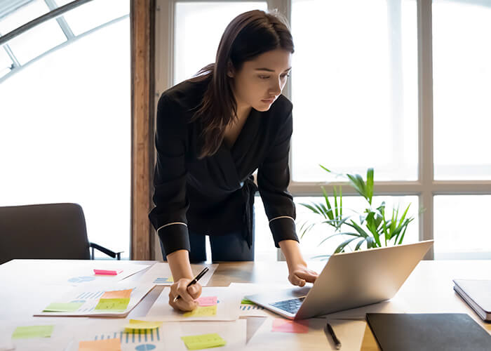 Financial Examiner In Front of Laptop