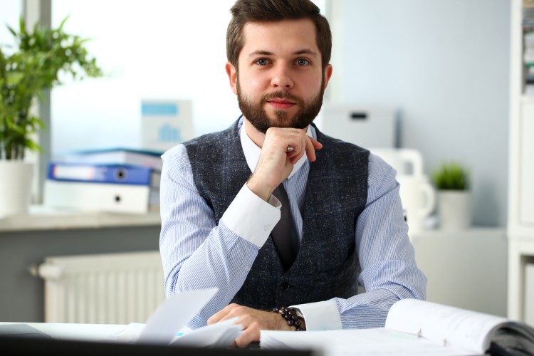 Social science research assistant works at desk