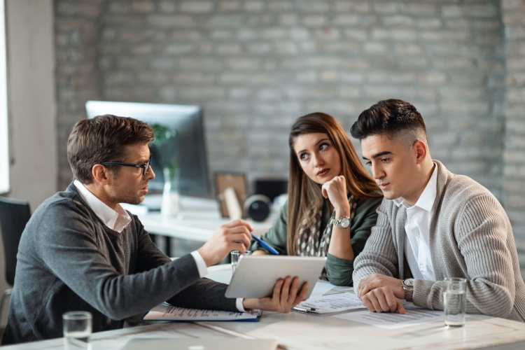 An accountant meets with two clients.