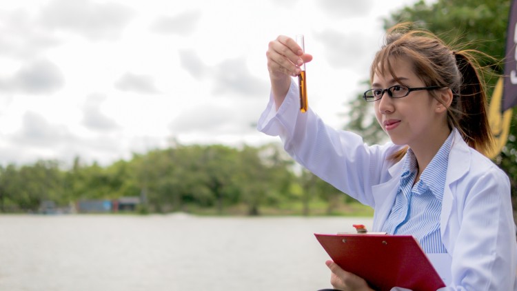 A hydrologist tests the water quality of a lake.