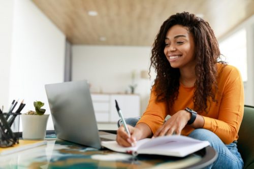 An online student works on a laptop.