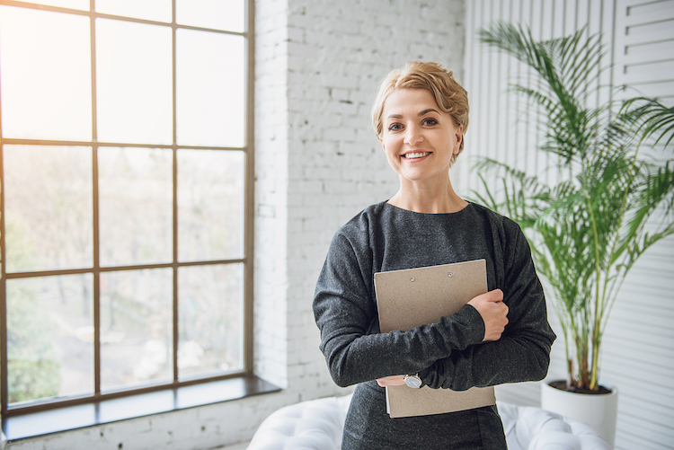 confident psychologist holding a clipboard