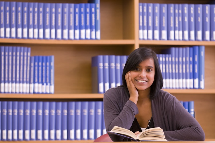 Records manager with a book in the library.