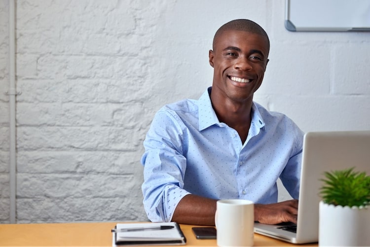 smiling business professional sitting at desk