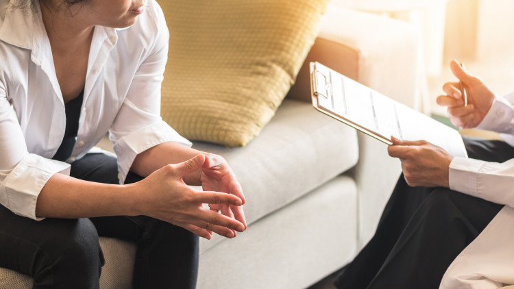 A substance abuse counselor talks to a patient.