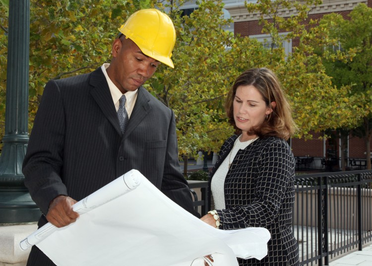 Urban planners review blueprints.