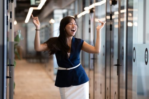 A person celebrates with a victory dance.