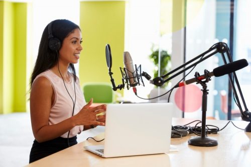 A podcaster records a show in the studio.