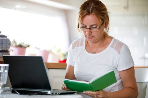 An adult student with a laptop and planner.