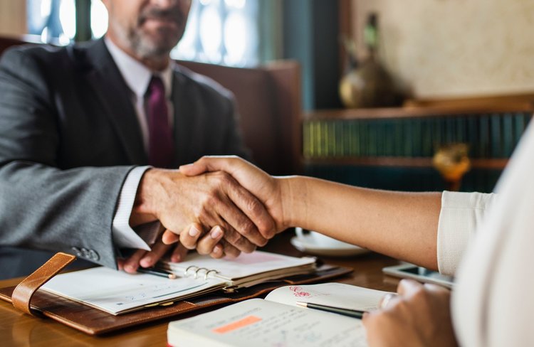 Two persons shaking hands.