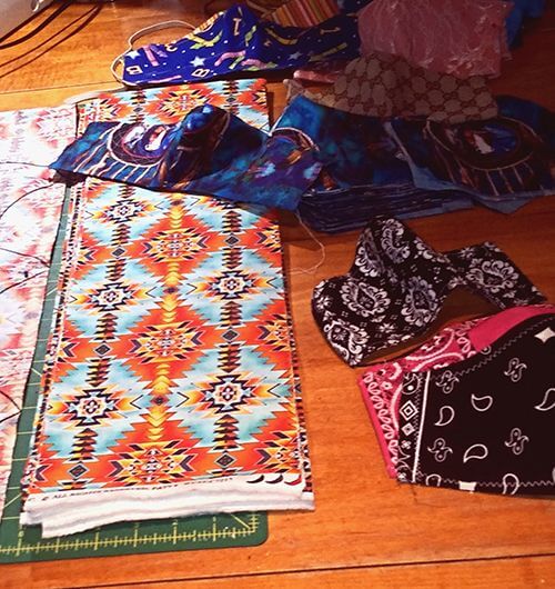 Colorful facemasks over a wood floor.